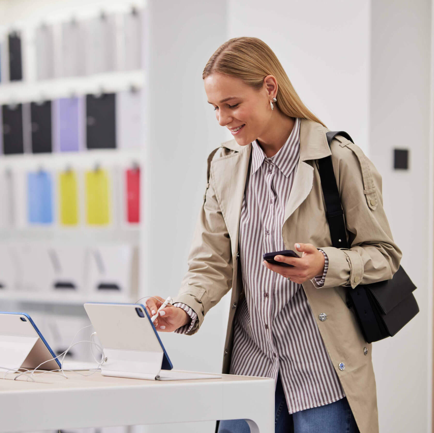 A person at a shop picking out a mobile device